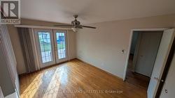 Master bedroom with french doors leading onto deck - 