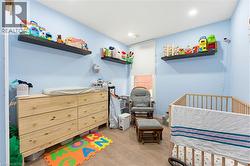 Room featuring light blue walls and wood-finish flooring - 