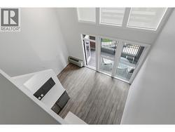 Dramatic two-storey living room with soaring ceilings and abundant natural light. - 