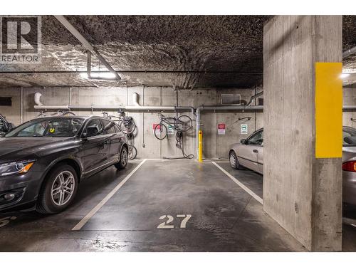 Secured Parking with EV Charging Station - 1775 Chapman Place Unit# 101, Kelowna, BC - Indoor Photo Showing Garage