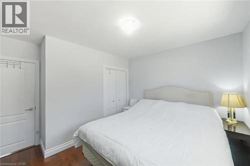 Neutral wall paint with crown molding and wood-finish flooring - 158 Plymouth Road, Kitchener, ON - Indoor Photo Showing Bedroom