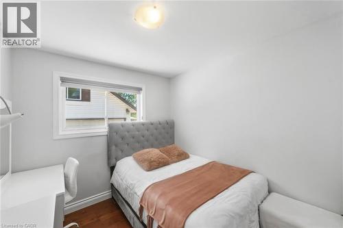 Room featuring wood-finish flooring, a single window with white trim, a flush-mount ceiling light fixture, and light gray wall paint - 158 Plymouth Road, Kitchener, ON - Indoor Photo Showing Bedroom