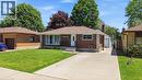Brick and stone exterior featuring a covered entry, black wrought iron railing, and a concrete driveway - 158 Plymouth Road, Kitchener, ON  - Outdoor With Facade 