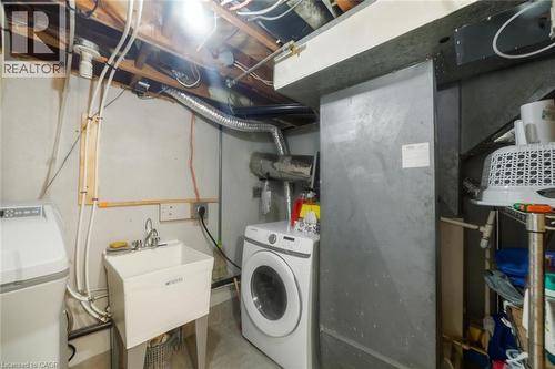 Laundry area featuring exposed ceiling joists, utility sink, and wall-mounted plumbing - 158 Plymouth Road, Kitchener, ON - Indoor Photo Showing Laundry Room