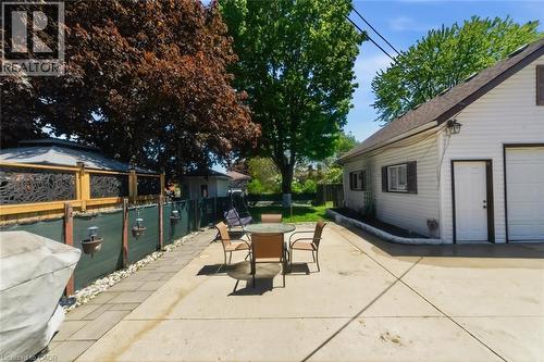 Expansive concrete patio with dedicated paved walkway - 158 Plymouth Road, Kitchener, ON - Outdoor
