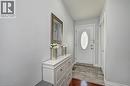 Entryway featuring a white door with an oval decorative glass insert, complemented by light gray wall paint - 158 Plymouth Road, Kitchener, ON 