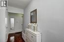 Hardwood flooring extending through the entry, neutral wall tones, and white trim - 158 Plymouth Road, Kitchener, ON 