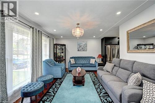 Bright living space with recessed lighting and a central chandelier - 158 Plymouth Road, Kitchener, ON 