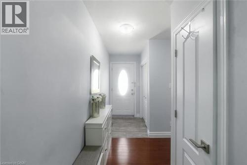 Entryway featuring a white door with an oval glass insert, a flush mount ceiling light, and light gray wall paint - 158 Plymouth Road, Kitchener, ON - Indoor Photo Showing Other Room