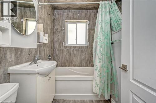 Bathroom featuring a white vanity with integrated sink, chrome faucet, and mirrored medicine cabinet - 158 Plymouth Road, Kitchener, ON 