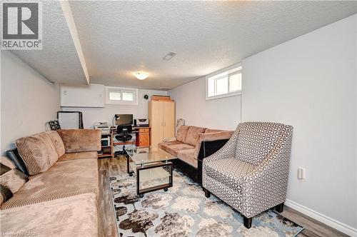 Finished basement space featuring light-colored walls, wood-finish flooring, and recessed lighting - 158 Plymouth Road, Kitchener, ON 