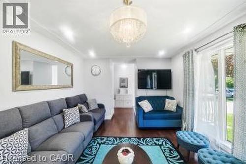 Spacious living area featuring hardwood flooring, recessed lighting, and a crystal chandelier - 158 Plymouth Road, Kitchener, ON - Indoor Photo Showing Living Room