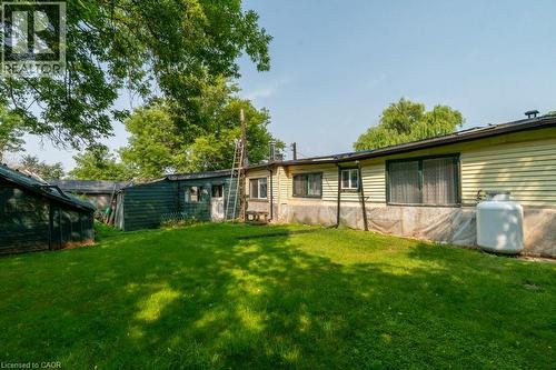 Expansive green lawn with mature trees provides a generous exterior space - 1264 Parkinson Road, Woodstock, ON 
