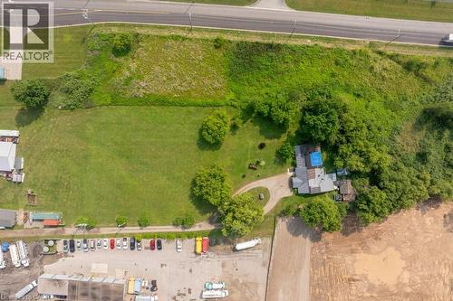 Expansive aerial showcasing a property with a residential structure, extensive green space, and mature trees - 1264 Parkinson Road, Woodstock, ON 