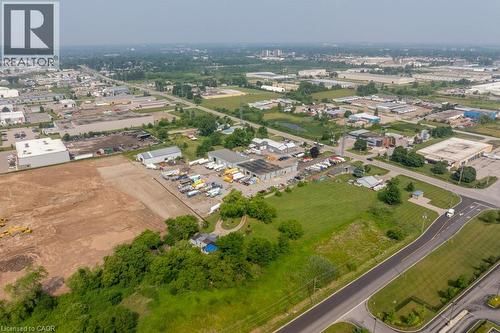 Expansive industrial and commercial landscape featuring multiple buildings, paved roadways, and undeveloped land parcels - 1264 Parkinson Road, Woodstock, ON 
