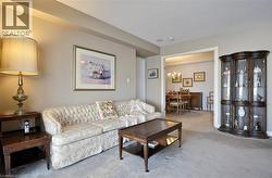 Living area featuring light-colored wall paint and carpet flooring - 