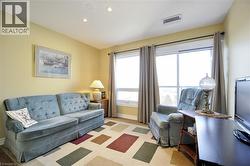 Bright room featuring two expansive windows, recessed ceiling lighting, and a neutral color palette - 
