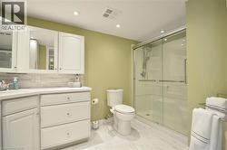 Bathroom with white vanity cabinetry, integrated sink, and a tiled backsplash - 