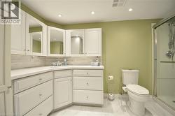 Bathroom featuring an extended vanity with white cabinetry, integrated sink, and white countertop - 