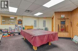 Recreation room featuring a pool table with a maroon cover - 