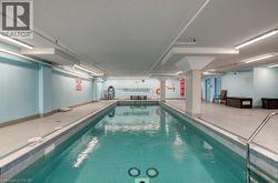 Indoor lap pool with mosaic tile detailing and perimeter deck - 