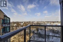 Balcony with glass panel railing and metal frame, offering an expansive outdoor outlook - 