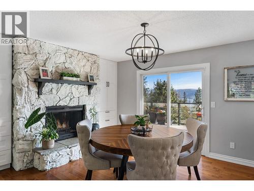 1659 Scott Crescent, Kelowna, BC - Indoor Photo Showing Dining Room With Fireplace