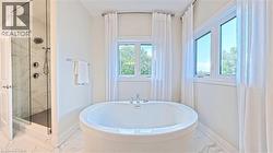 Freestanding oval bathtub with polished chrome fixtures - 