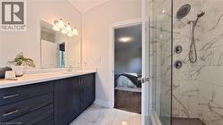 Contemporary bathroom featuring a dark wood-finish vanity with ample storage, a white countertop, and a rectangular undermount sink - 