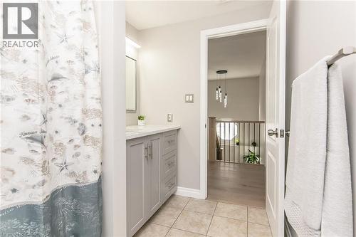 Neutral-toned bathroom featuring a single vanity with a light countertop and gray cabinetry - 529 Chesapeake Crescent, Waterloo, ON - Indoor Photo Showing Bathroom