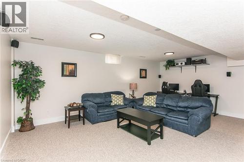 Carpeted recreational room featuring recessed lighting, a built-in media shelf, and white walls - 529 Chesapeake Crescent, Waterloo, ON - Indoor