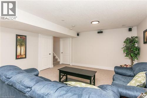 Finished lower level featuring neutral carpeting, recessed lighting, white trim, and a built-in speaker system - 529 Chesapeake Crescent, Waterloo, ON - Indoor