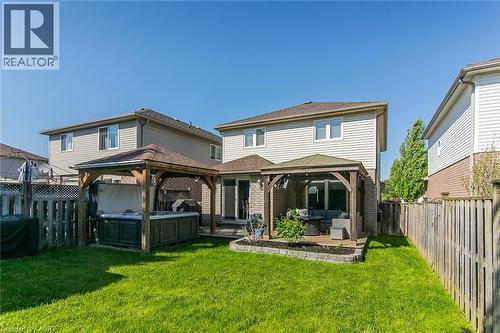 Expansive backyard featuring a lush lawn and two dedicated covered patio areas - 529 Chesapeake Crescent, Waterloo, ON - Outdoor With Deck Patio Veranda