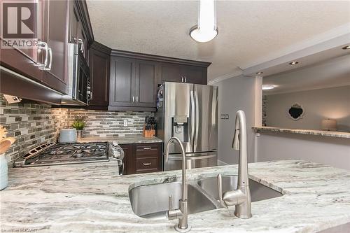 Kitchen island featuring a double basin stainless steel sink with a gooseneck faucet - 529 Chesapeake Crescent, Waterloo, ON - Indoor Photo Showing Kitchen With Double Sink With Upgraded Kitchen