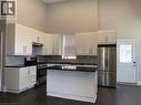 Unit 1 Contemporary kitchen featuring white cabinetry, dark countertops, and stainless-steel appliances - 405 Macnab Street N, Hamilton, ON 