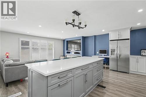 Spacious kitchen island with a white countertop and grey cabinetry - 44 Oakhurst Crescent, Kitchener, ON - Indoor Photo Showing Kitchen