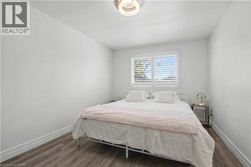 Bright room featuring wood-finish flooring and white baseboards - 44 Oakhurst Crescent, Kitchener, ON - Indoor Photo Showing Bedroom