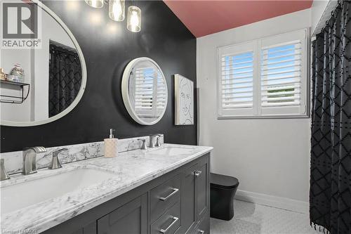 Dual vanity with marble-finish countertop, two undermount sinks, and brushed nickel faucets - 44 Oakhurst Crescent, Kitchener, ON - Indoor Photo Showing Bathroom