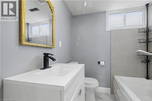 Bathroom featuring a white vanity with integrated sink, black matte faucet, and a gold-framed mirror - 44 Oakhurst Crescent, Kitchener, ON - Indoor Photo Showing Bathroom