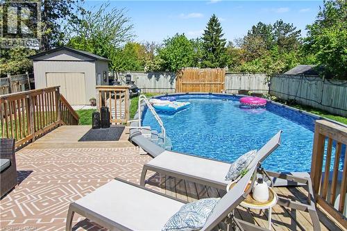 Wood deck with an above-ground pool, providing a prominent outdoor living space - 44 Oakhurst Crescent, Kitchener, ON - Outdoor With Above Ground Pool With Deck Patio Veranda With Backyard