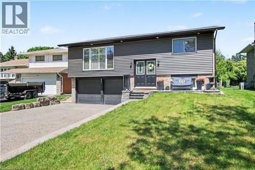 Modern split-level residence featuring dark gray siding and stone accents - 44 Oakhurst Crescent, Kitchener, ON - Outdoor