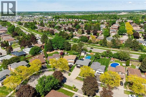 Aerial perspective of a residential area featuring numerous detached homes with varied rooflines and extensive tree coverage - 44 Oakhurst Crescent, Kitchener, ON - Outdoor With View