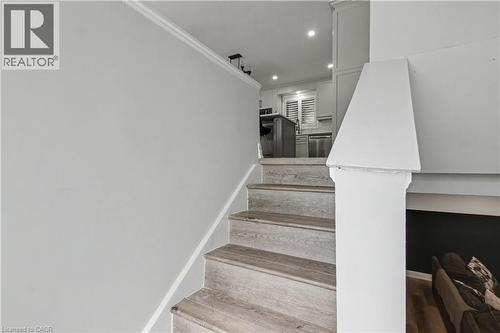Wood-finish staircase with white risers and a white newel post - 44 Oakhurst Crescent, Kitchener, ON - Indoor Photo Showing Other Room