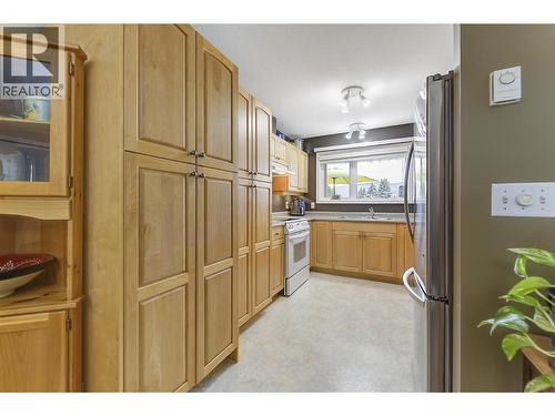 Beautiful Maple Cabinets in Kitchen, Fridge and Dishwasher are new last year. - 1672 Thayer Court, Kelowna, BC - Indoor Photo Showing Kitchen