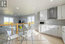 UPPER LEVEL KITCHEN OVERLOOKING GLASS RAILING & LR - 