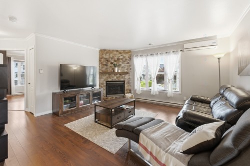 Salon - 201-69 Rue Des Corbières, Terrebonne (Lachenaie), QC - Indoor Photo Showing Living Room With Fireplace