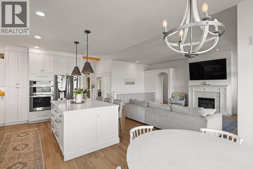 Kitchen, Breakfast Nook & Living - 629 Almandine Court, Kelowna, BC - Indoor With Fireplace
