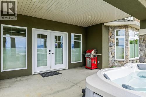 Lower Level Patio with Hot Tub - 629 Almandine Court, Kelowna, BC - Outdoor With Deck Patio Veranda With Exterior