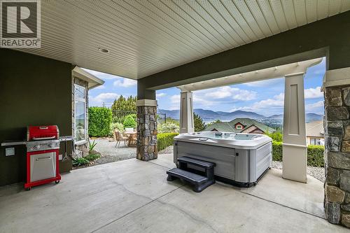 Lower Level Patio with Hot Tub - 629 Almandine Court, Kelowna, BC - Outdoor With Exterior
