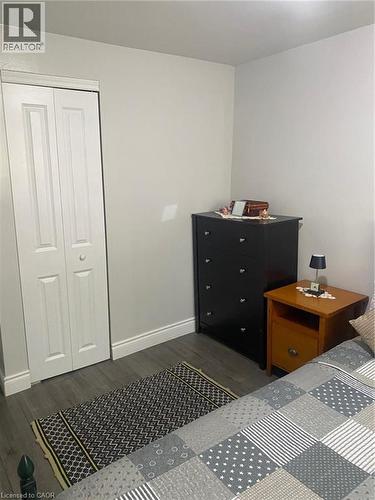 Bedroom featuring dark wood-style flooring and a closet - 58 Hazelglen Drive, Kitchener, ON - Indoor Photo Showing Bedroom